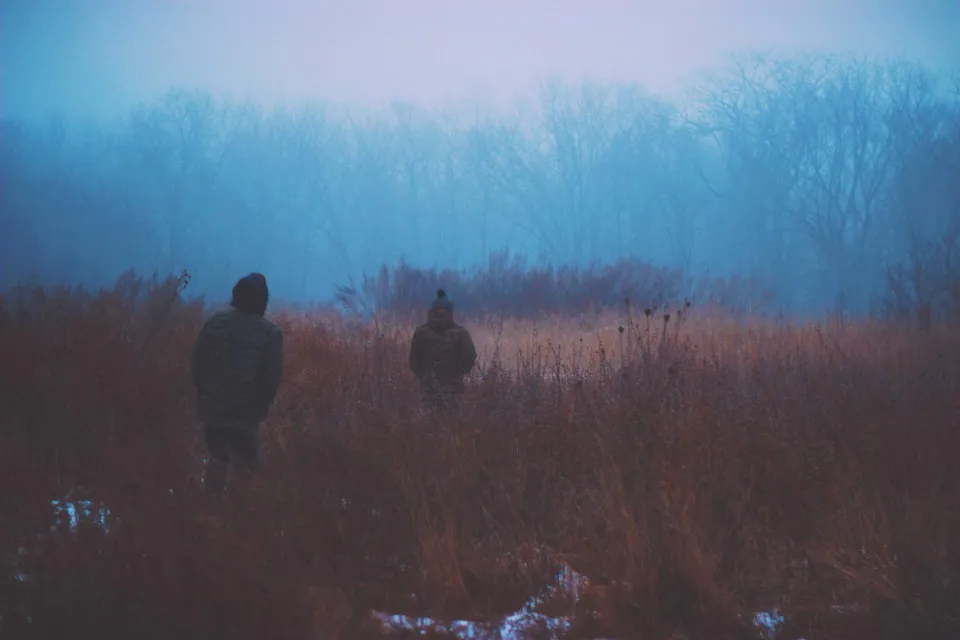 Frozen lake with mountain reflections and winter landscape