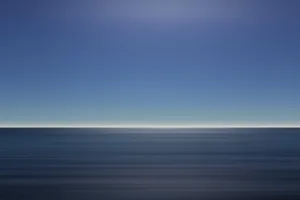 Dramatic ocean cliffs at sunset with crashing waves