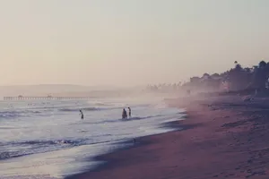Busy night market with food stalls, lanterns, and crowds